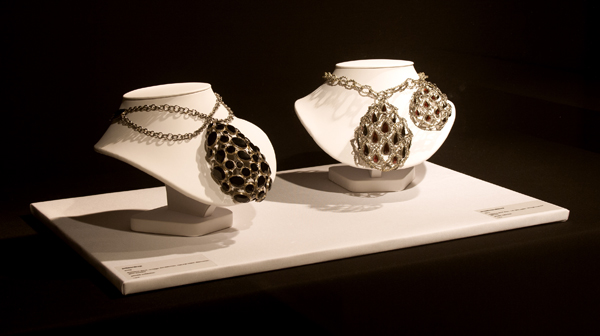 Lola Brooks, (left to right): Jetteardrop, 2009, pendant, stainless steel, vintage rhinestones, natural black diamonds, gold solder, 4.5 x 3 x 1.25 inches, 16-inch chain, Private Collection; bloodbowsandtears, 2012, pendants, stainless steel chain, 14-karat gold solder, vintage rose-cut garnets, 22 inches long, Private Collection, photo: The National Ornamental Metal Museum